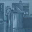 Photograph of City employee helping man at front desk inside of City Hall